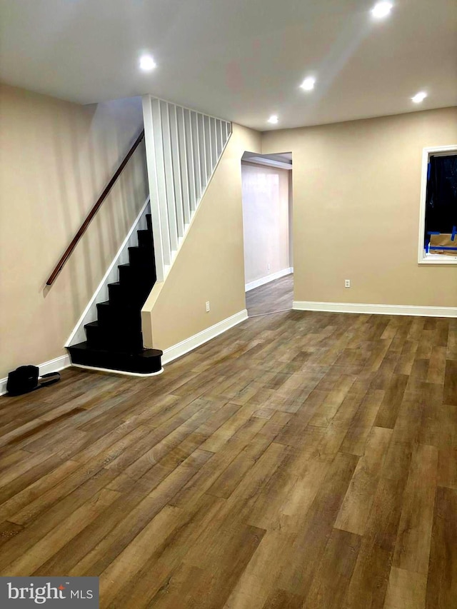 finished basement featuring stairs, baseboards, wood finished floors, and recessed lighting