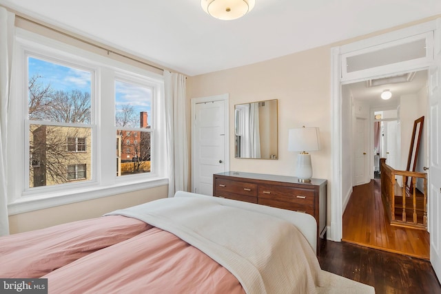 bedroom with dark wood finished floors