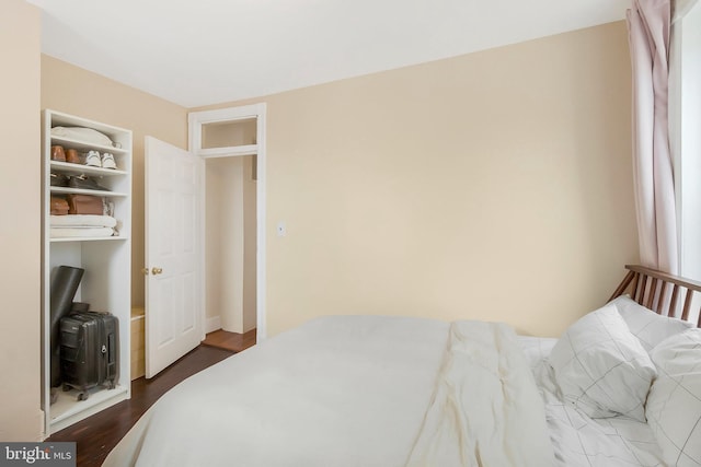 bedroom with dark wood-type flooring