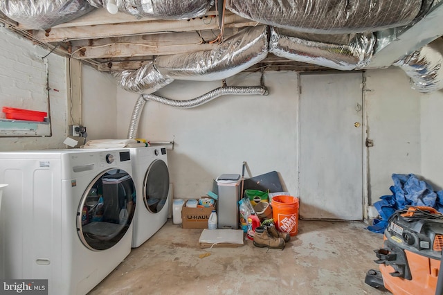 clothes washing area with laundry area and washer and clothes dryer