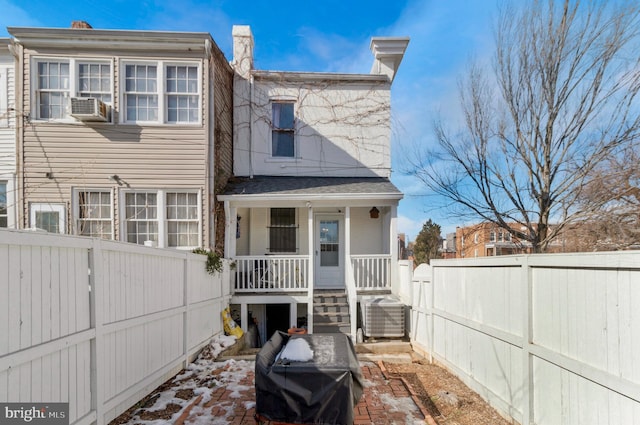 back of house featuring a porch, central AC, and a fenced backyard