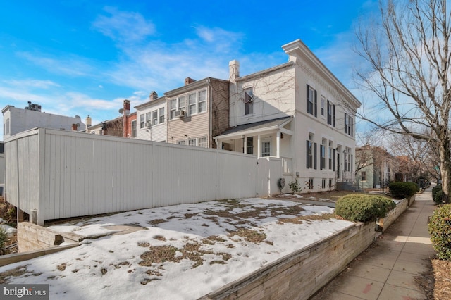 view of home's exterior featuring a residential view and fence