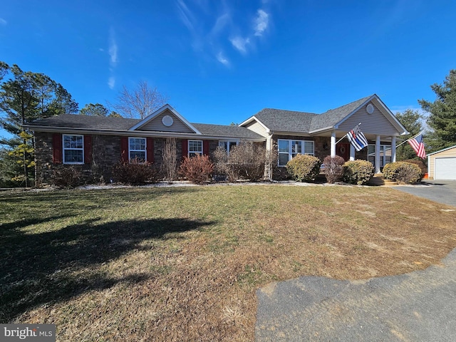 single story home with an outbuilding and a front lawn