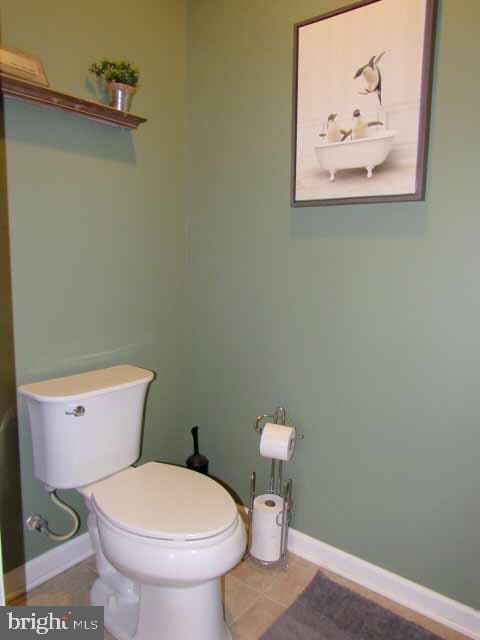 bathroom with toilet and baseboards