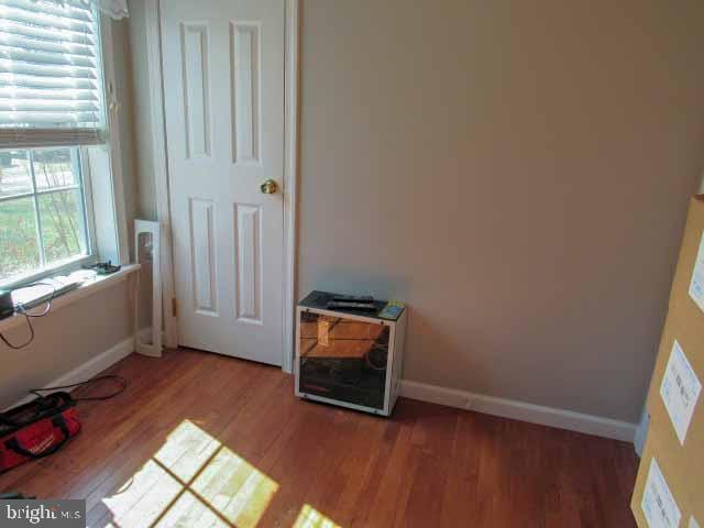 unfurnished bedroom with light wood-style flooring and baseboards