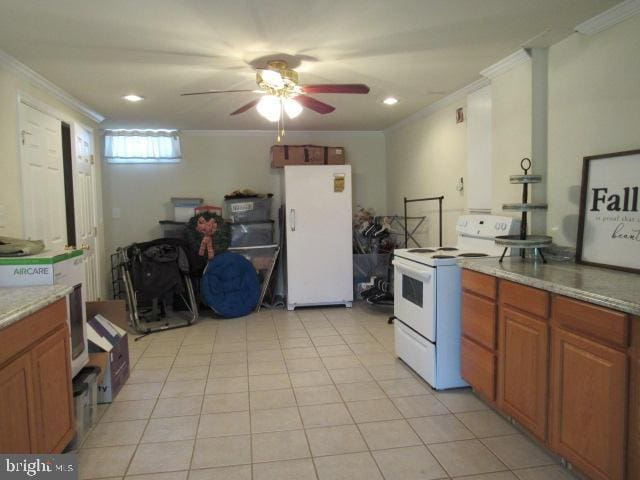 kitchen with brown cabinets, ornamental molding, a ceiling fan, white appliances, and light tile patterned floors