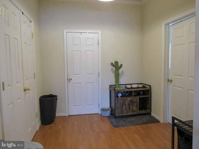 foyer entrance featuring wood finished floors and baseboards