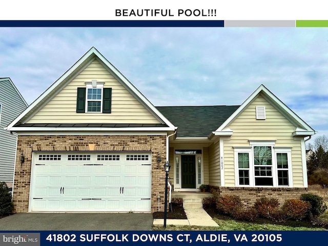 view of front of home with a garage, brick siding, and driveway