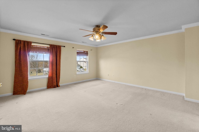 spare room featuring ceiling fan, light carpet, baseboards, and ornamental molding