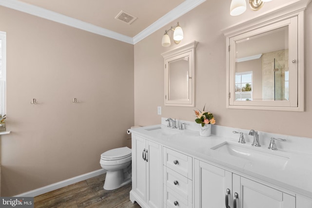 full bath featuring a sink, visible vents, toilet, and crown molding