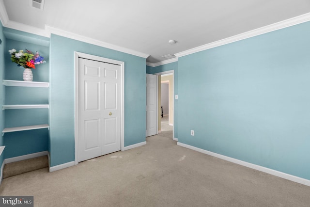 unfurnished bedroom featuring visible vents, baseboards, carpet flooring, and crown molding