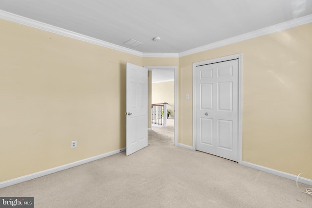 unfurnished bedroom featuring baseboards, ornamental molding, and carpet flooring