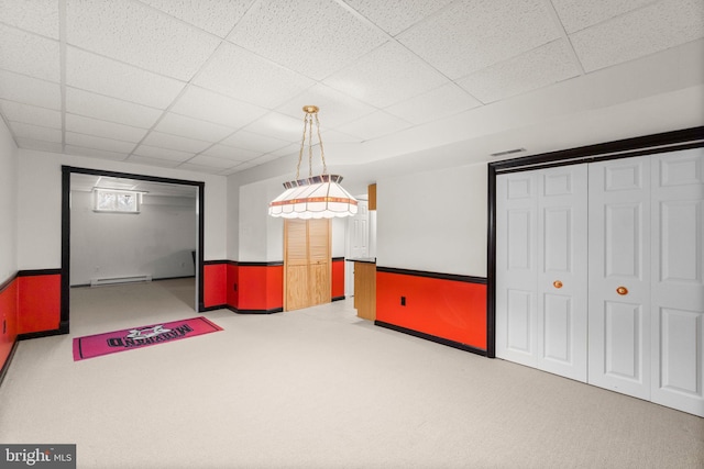 rec room with a drop ceiling, visible vents, baseboard heating, and carpet flooring