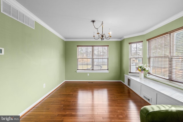 unfurnished dining area with visible vents, a healthy amount of sunlight, and hardwood / wood-style floors