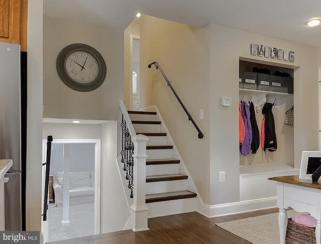 stairs featuring wood finished floors