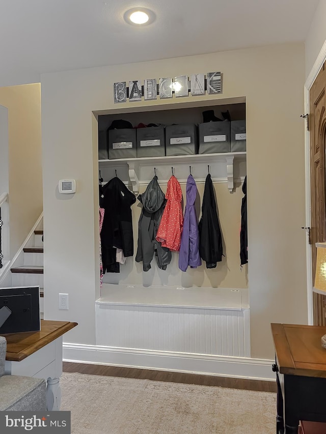 mudroom featuring baseboards and wood finished floors