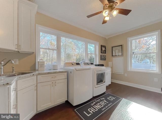 laundry room featuring a wealth of natural light, cabinet space, a sink, and washing machine and clothes dryer