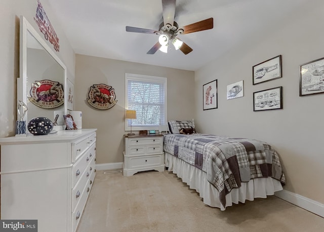 bedroom featuring light colored carpet, ceiling fan, and baseboards