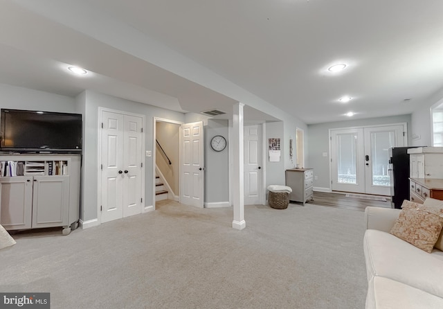 living area featuring carpet, french doors, visible vents, stairway, and baseboards