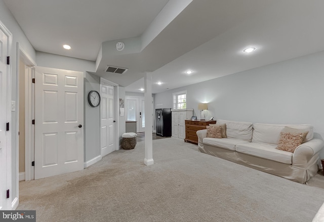 living room with baseboards, recessed lighting, visible vents, and light colored carpet