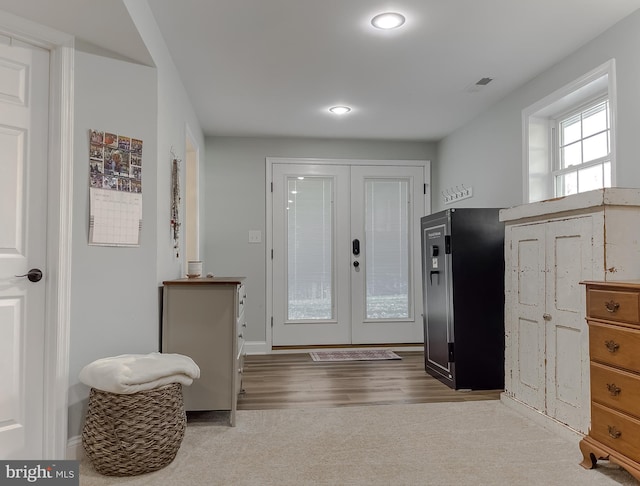 carpeted entryway featuring french doors and visible vents