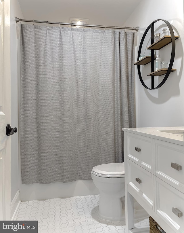 bathroom featuring toilet, tile patterned floors, and vanity