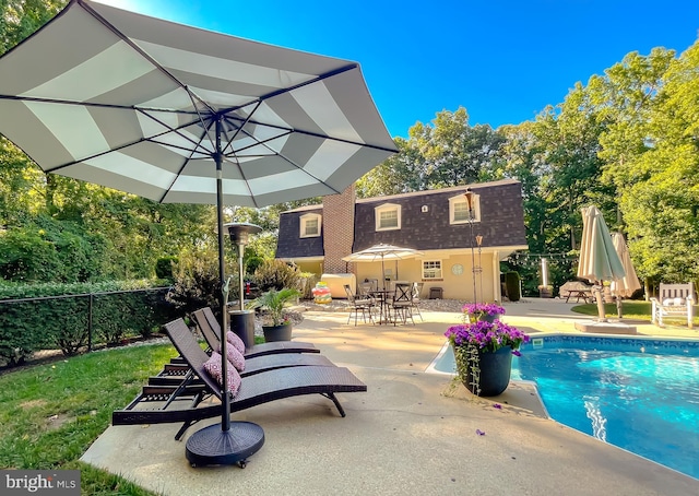 outdoor pool featuring a patio and fence