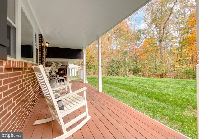 wooden terrace with a yard