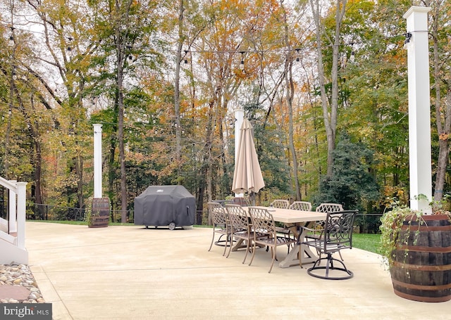 view of patio / terrace featuring outdoor dining area, fence, and grilling area