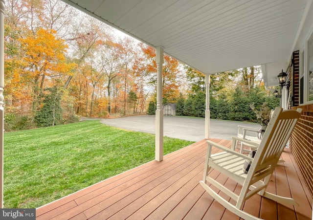 wooden deck with a lawn