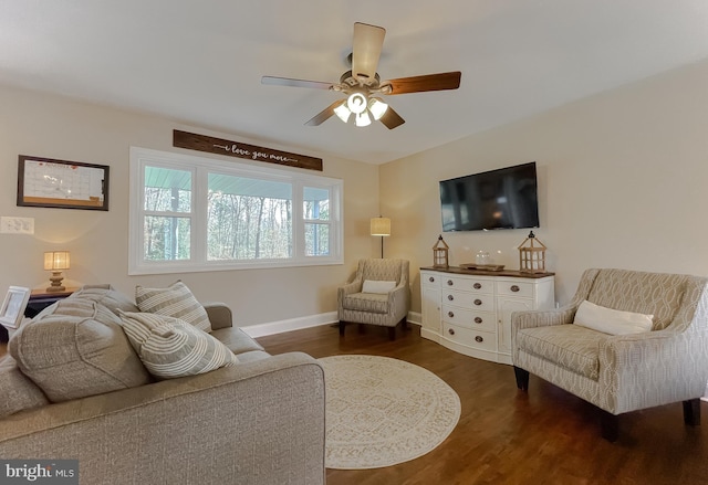 living room with a ceiling fan, dark wood finished floors, and baseboards