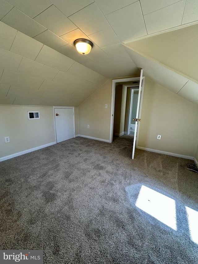 bonus room with vaulted ceiling, carpet, visible vents, and baseboards