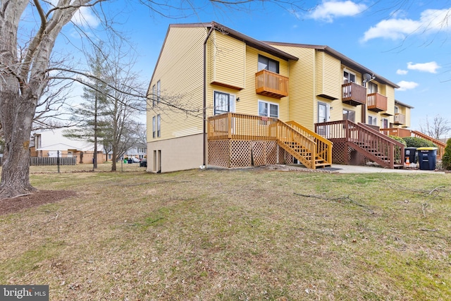 rear view of property with a lawn