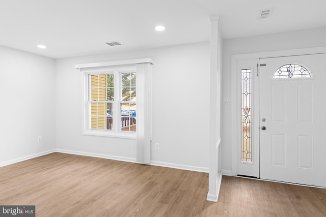 entryway featuring visible vents, baseboards, and wood finished floors