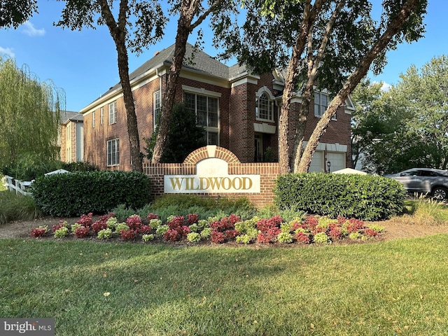 community sign with a lawn and a garage