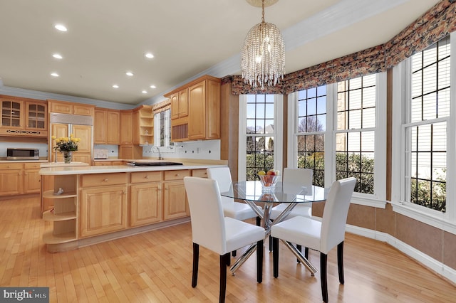 dining space featuring recessed lighting, a notable chandelier, baseboards, and light wood-style floors