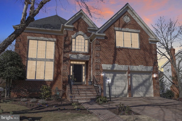 traditional home with concrete driveway, a garage, brick siding, and a shingled roof