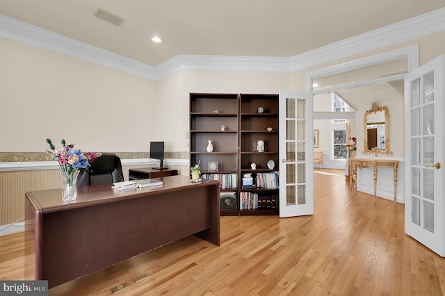 office with light wood finished floors, french doors, and crown molding