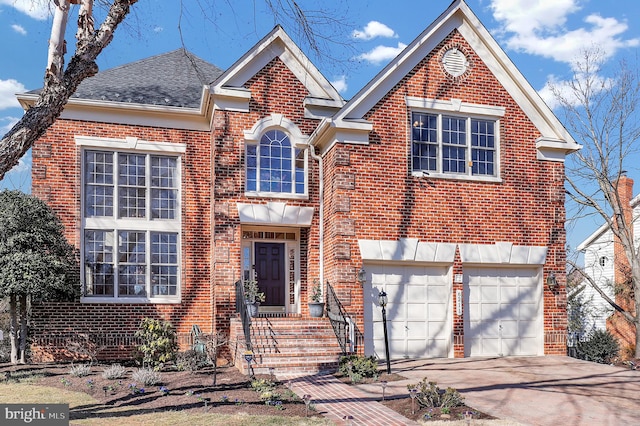 traditional home with a garage, brick siding, driveway, and a shingled roof