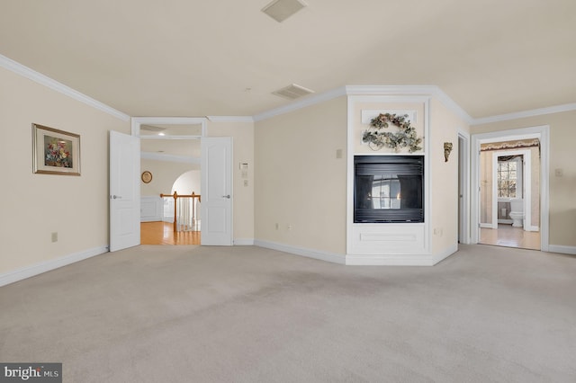 unfurnished living room with crown molding, light colored carpet, and visible vents