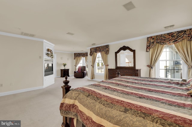 bedroom with visible vents, ornamental molding, a glass covered fireplace, baseboards, and light colored carpet