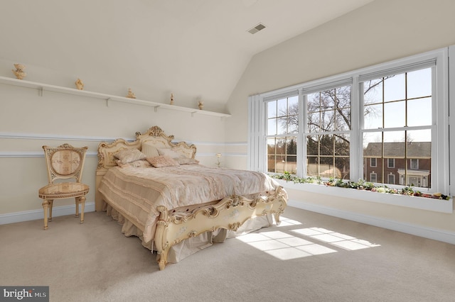 carpeted bedroom featuring visible vents, baseboards, and vaulted ceiling