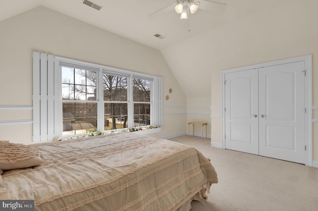 bedroom featuring lofted ceiling, visible vents, and light carpet