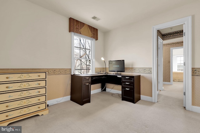 office with visible vents, wainscoting, wallpapered walls, and light colored carpet