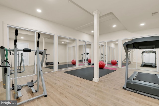 workout room featuring recessed lighting, wood finished floors, and visible vents