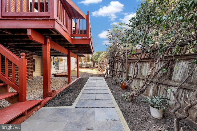 view of patio featuring a deck and fence