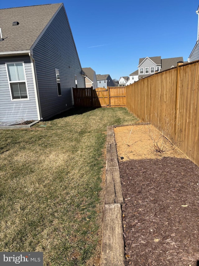 view of yard with a residential view and a fenced backyard