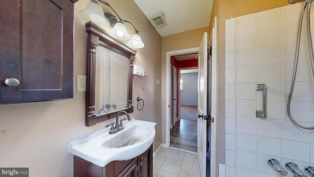 bathroom with tile patterned flooring, visible vents, baseboards, and vanity