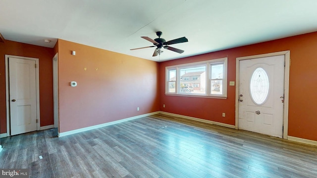 foyer with ceiling fan, baseboards, and wood finished floors