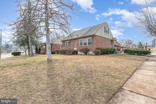 view of side of property featuring a yard and brick siding